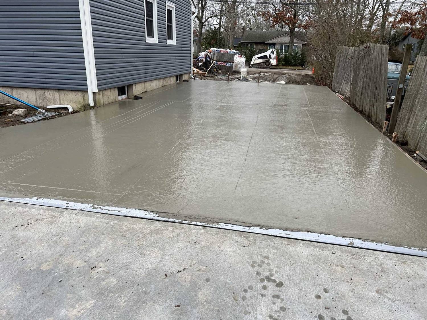 Your New Concrete Driveway's First Winter: Salt, Plows and Sealer