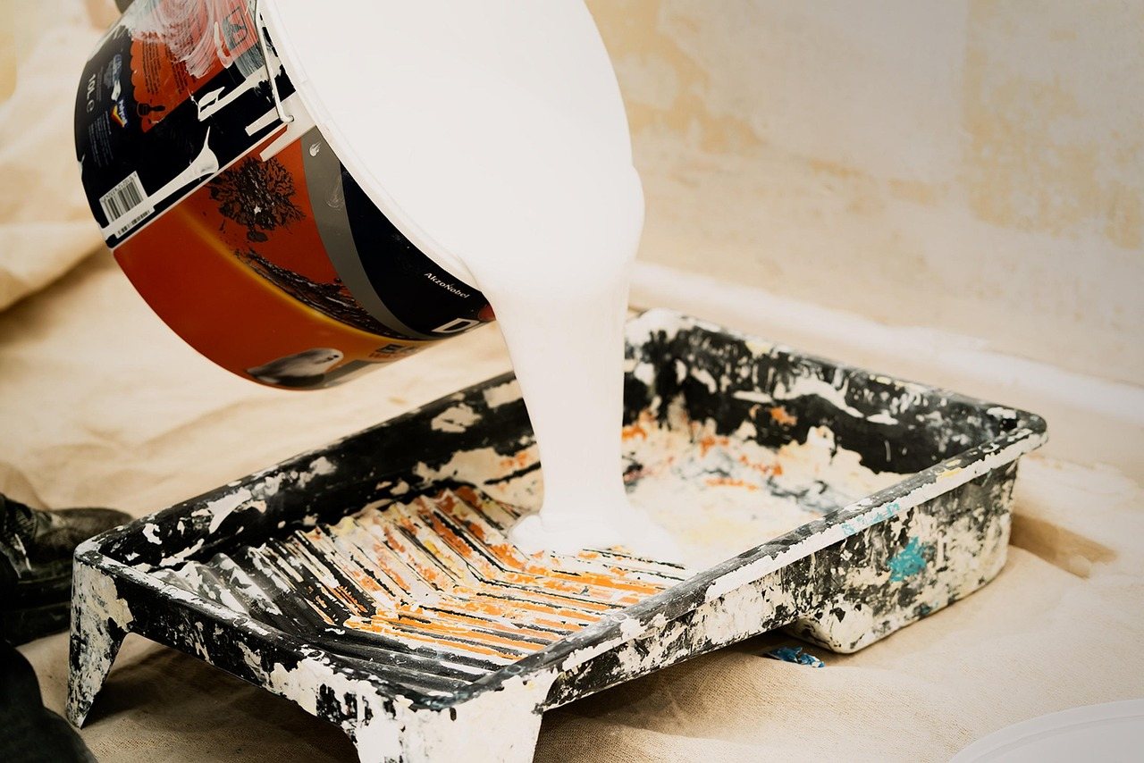 Paint poured into a tray before cutting in a room
