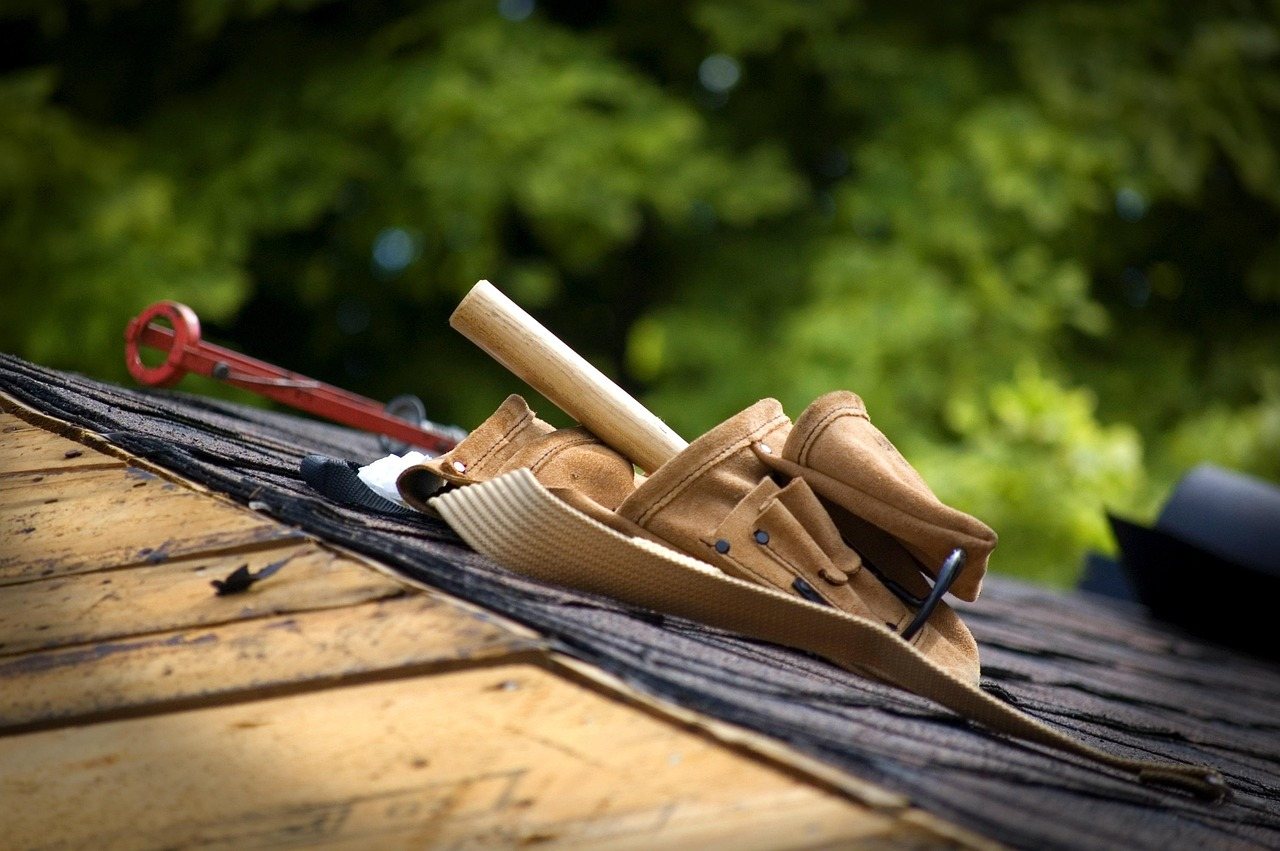 Roofing tools laid out on the deck before a shingle install