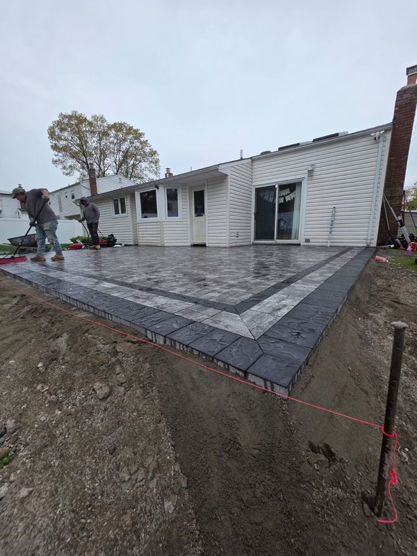 Backyard patio, grey field with a charcoal border by JDG Concrete & Construction