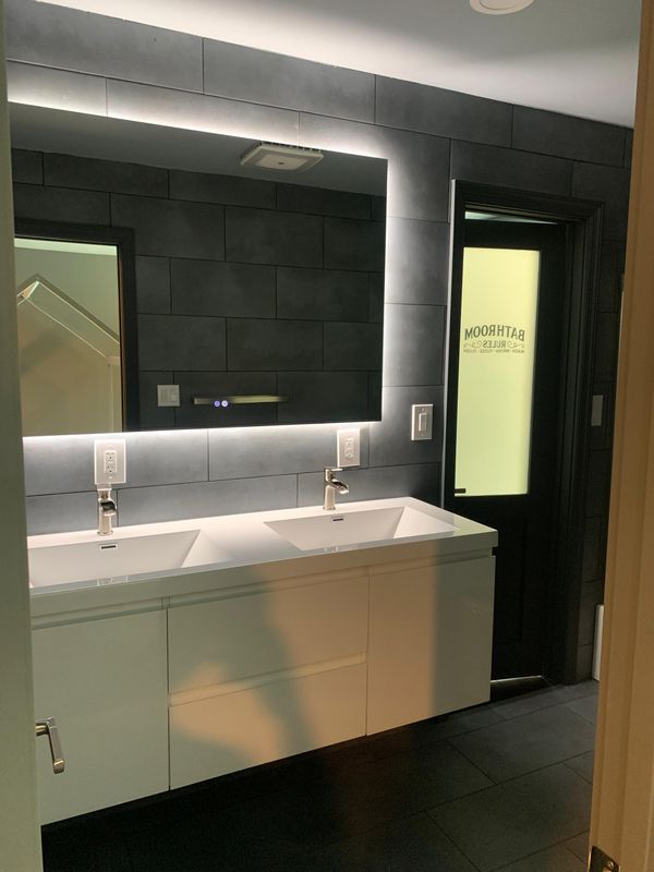 Vanity wall and shower from the entry by JDG Concrete & Construction