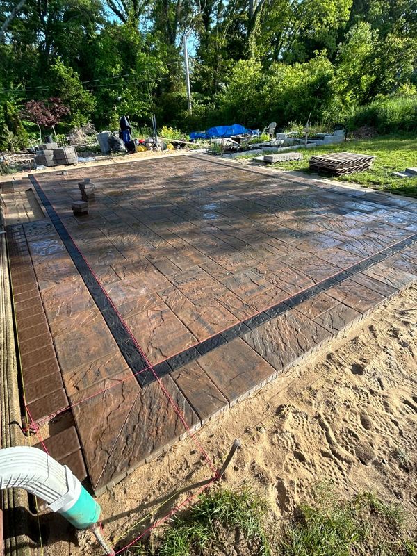 Patio field with a double-band border by JDG Concrete & Construction