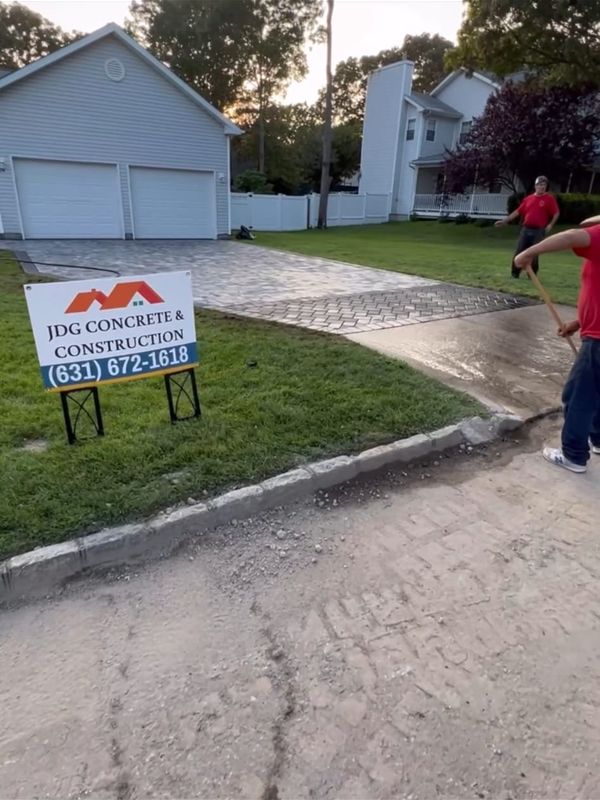 Finished paver driveway, sign still up by JDG Concrete & Construction