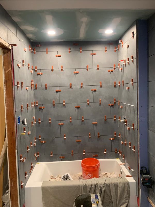 Tub surround tiled, grout to come by JDG Concrete & Construction