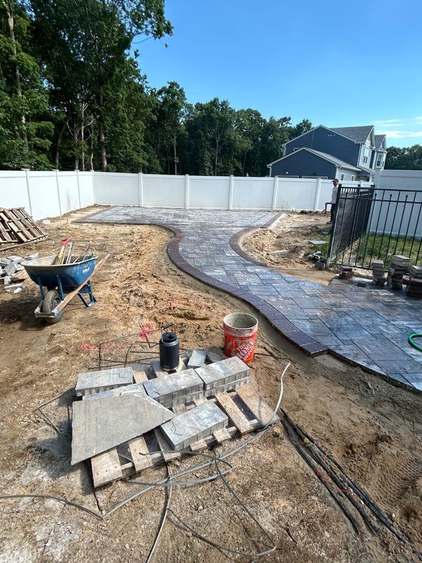Curved walkway going in, border set first by JDG Concrete & Construction