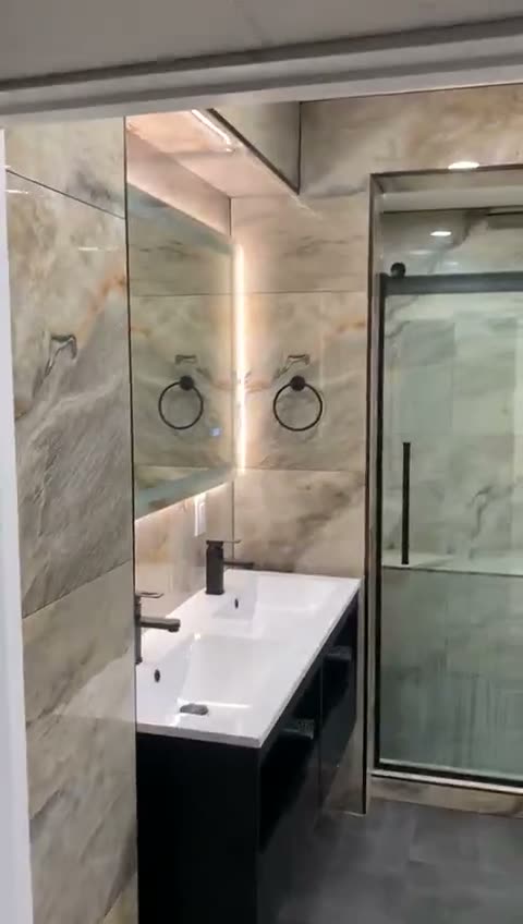 Marble-look bath walkthrough by JDG Concrete & Construction