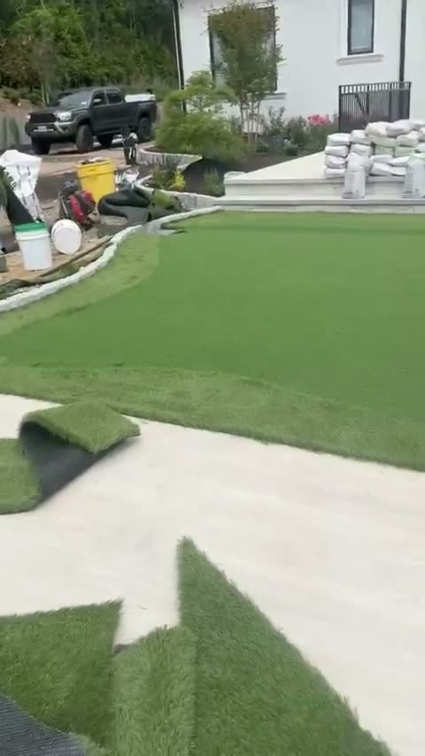 Artificial turf laid against new concrete by JDG Concrete & Construction